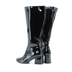 The Classic 1960's Inspired Patent Mod Boot Proud To Be 100% Vegan Friendly Upper Material: Faux Patent Leather Lining Material: Man Made Material + Fabric Canvas Lining Sock: Fully Padded With Memory Foam For Maximum Comfort. Inside Side Zipper Closure / Inside Elastic Heel Height: 2 1/2" Inches Approximate Shaft Height: From Back Counter To Top Of Shaft (measurements from a size 6) 13 1/4" Approximate Fits True To Size. For Additional Sizing Suggestions, Please Contact Customer Care, We're Hap Retro Black Boots For Fall, Retro Black Boots For Party, Fitted Vintage Black Boots, Vintage Black Winter Boots, Knee-high Patent Leather Boots With Reinforced Heel, Ankle-high Patent Leather Boots With 4-inch Heel, Sleek Black Patent Leather Knee-high Boots, Medium Width Patent Leather Ankle-high Heeled Boots, Black Leather Knee-high Boots With Zipper