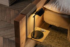 a lamp is sitting on the floor next to a bed