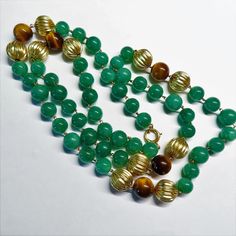 On offer is this elegant Vintage Chinese Export Necklace featuring Imperial Green Aventurine Tiger's Eye and large solid 14 karat Yellow Gold Corrugated beads with a 14k Gold Ring Clasp that opens and closes tightly. The Green Aventurine beads are in two sizes a large 9 mm and 8 mm gems with the Tiger's Eye gems measuring 10 mm in diameter and highlighted with gorgeous huge 11 mm diameter solid 14k yellow gold corrugated beads linked together with gold metal wire. Hallmarked 14k on the clasp. A Tigers Eye Gem, Eye Gems, Chinese Export, 14k Gold Ring, Metal Wire, Eye Necklace, Green Aventurine, Antique Vintage, Antique Jewelry