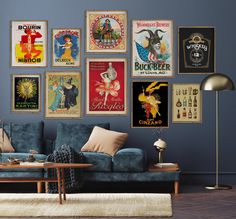 a living room filled with furniture and lots of posters on the wall above it's couch