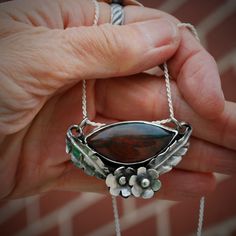 This incredible fancy jasper stone is set in sterling silver, accented in flowers and leaves. The overall effect is feminine and elegant. Fancy Jasper, Larimar Earrings, Blue Onyx, Soldering Jewelry, My Community, Moonstone Necklace, Jasper Stone, Jewelry Inspo, Silver Flowers