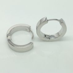 18 gauge sterling silver hoop earrings for men. Handmade from solid high quality 925 sterling silver and plated in yellow gold. Sold as a pair or single earring. Specification Base metal: 925 sterling silver Outer plating: white gold, polished Outer diameter: 17mm Inner diameter: 13mm, size L Width: 3.5mm Measurements are an approximation Ear post gauge: 18G Link to customize ear post gauge https://www.etsy.com/listing/245008458 More gauged earrings https://www.etsy.com/shop/360JewelsElite?ref=h Pierced Stainless Steel Huggie Earrings, Silver Huggie Stainless Steel Earrings, Modern White Gold Round Cartilage Earrings, White Gold Stainless Steel Hoop Jewelry, Minimalist White Gold Hoop Piercings, Minimalist White Gold Hoop Piercing, Modern Nickel-free Small Hoop Jewelry, Adjustable Stainless Steel Huggie Jewelry, Nickel-free Stainless Steel Huggie Earrings