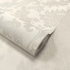 a close up view of a wallpaper with white and grey designs on it's surface