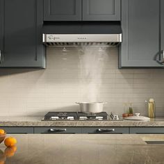 a stove top oven sitting inside of a kitchen under a faucet over a sink