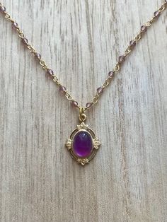 This vintage-inspired necklace is handmade using a 2mm genuine amethyst wire-wrapped chain and a 12x17mm pendant with an authentic 6x8mm amethyst. Amethyst promotes peace, clarity and cleanses energy.  The necklace comes in a ribbon-wrapped box, ready to be gifted. If you would like to leave a note for the recipient, you can do so during checkout. Please note that each stone is unique and varies in color. Gold Amethyst Necklace For Healing, Vintage Amethyst Jewelry For Healing, Gold Amethyst Jewelry With Delicate Chain, Elegant Gold Amethyst Crystal Necklaces, Gold Amethyst Bohemian Necklace, Bohemian Gold Amethyst Necklaces, Purple Amethyst Oval Pendant Necklace, Bohemian Amethyst Gold Necklace, Handmade Amethyst Gold Necklace