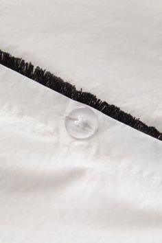 a close up of a white shirt with black trim