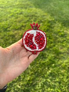 Pomegranate Brooch, Red Fruit Pin, Unique Birtday Gift for Woman, Embroidered Pomegranate Jewelry, Pomegranate Chiristman Accessory Pin  I made a pomegranate brooch, the symbol of abundance. The cute and sparkling Pomegranate brooch can be a beautiful and meaningful gift for yourself or your loved ones. The materials I use are of high quality. I used Swaravski pearls, crystal stones, natural pearls, Japanese stones, zircon stones, stone strips, Swarovski bicone stones. I covered the back surface with red faux leather and used an unbreakable steel needle. It will add sparkle to your clothes. My brooches are sent to you in a special gift box. You can send me a message with your questions and requests.🌸♥️ Traditional Red Brooches For Gifts, Traditional Red Brooch For Gift, Traditional Handmade Red Brooches, Traditional Red Handmade Brooch, Pomegranate Jewelry, Godfather Gifts, Pearls Diy, Godmother Gifts, Gift For Woman