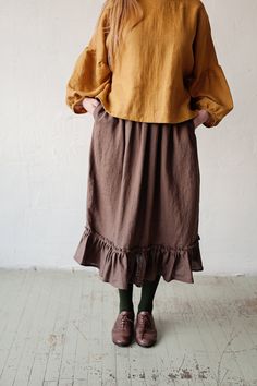 Victorian style inspired ruffle petticoat skirt is made from 100% soft and washed linen. This Petticoat is perfect for wearing under dress or other skirt or can be worn alone. Match it with our tunics! Details: - Composition: 100% Oeko-Tex certified linen - Colour: chocolate brown - Pockets - Elastic waist - Size: One size/fits all - Medium weight linen - Linen care: machine wash gentle; tumble dry low, ironing optional - The price is for one skirt, other pictured items are not included Relaxed Fit Lined Tiered Skirt, Brown Cotton Gathered Skirt Bottoms, Brown Cotton Bottoms With Gathered Skirt, Brown Ruffled Long Skirt, Voluminous Midi Skirt With Ruffle Hem, Solid Long Skirt With Ruffles, Long Ruffle Hem Relaxed Skirt, Long Relaxed Skirt With Ruffle Hem, Brown Tiered Ruffle Skirt