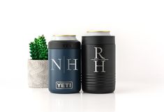 two black and blue can coolers next to a potted succulent plant