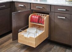 an open drawer in the middle of a kitchen