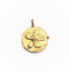 "This beautiful 14 Karat yellow gold \"Flower Locket\" pendant is embellished with a diamond of 0.02 ct. on the center and all handmade by Carolyn. Diamonds approx. 0.02 ct. weight Total weight of gold is 5 grams. Bale would accommodate approx. 1.5 - 2mm chain. Can be ordered in rose or white gold. 14K Yellow Gold 16\" long chain can be purchased separately for $80." Gold Angel Wings, Gold Locket, Evil Eye Charm, Gold Flower, Long Chain, Gold Flowers, Charm Pendant, Locket, Jewelry Necklace Pendant