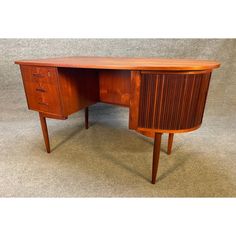 a wooden desk sitting on top of a carpeted floor