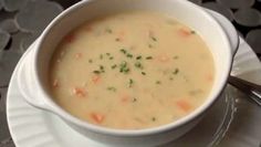 a white bowl filled with soup on top of a plate