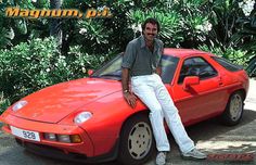 a man sitting on the hood of a red sports car