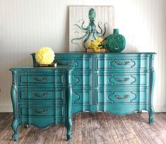 two blue dressers sitting next to each other on top of a hard wood floor