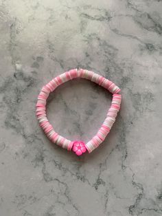 This is a clay bead  bracelet I made that is comfortable, fits kids and adults, and also is very cute! This bracelet does NOT pinch your skin while wearing. This bracelet is also very flexible! Enjoy! Clay Bead Bracelet, Comfortable Fits, Clay Bead, Bracelet I, Exercise For Kids, Clay Beads, Bead Bracelet, Pink Flower, Pink Flowers