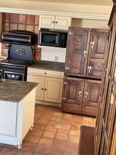 a kitchen with an oven, refrigerator and sink