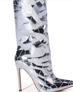 The RENAISSANCE TOUR Shattered Metallic Stiletto Boot In Silver features a faux suede upper, a thigh high shaft, a slim stiletto heel, a pointed toe silhouette, and an inner ankle zipper closure. Complete with reflective metallic crackle detailing throughout. Walk with the stars in these luxurious Shattered-Silver Stiletto Boots, crafted with a sleek, pointed toe and eye-catching shattered glass pattern. Fit for a diva, these over the knee boots are sure to make a statement with their shimmering Boutique Couture, Stiletto Boots, Stiletto Pumps, Long Boots, Shoe Closet, Black High Heels, Thigh High, Stiletto Heel, Thigh Highs