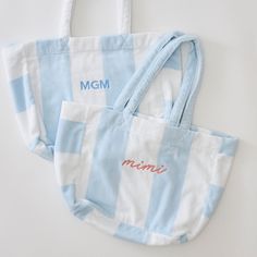 Meet our vacation-ready Beach Bag. Sized to fit sunny day essentials, our terry tote is perfectly packable for weekends away. Made of our fan-favorite Light Blue Stripe Beach Towel, the long straps and pocket make for sun, sand and swim made Weezie. Summer Tote Shoulder Bag With Embroidered Logo, Summer Shoulder Bag With Embroidered Logo, Tote Style, Casual Embroidered Beach Bag, Summer Rectangular Bag With Embroidered Logo, Summer Weekend Cotton Beach Bag, Summer Shoulder Bag With Embroidered Logo For Daily Use, Travel Shoulder Bag With Embroidered Logo, Summer Weekend Cotton Bag, Embroidered Travel Bags For Beach Season