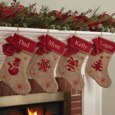 christmas stockings hanging from a mantel over a fireplace