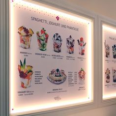 a display case with different types of desserts on it's sides and lights above them