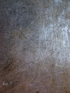 an old metal surface with scratches on it