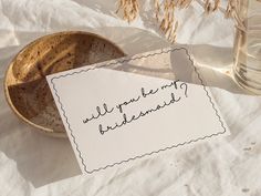 an empty bowl with a note that says, will you be my bridesmaid?