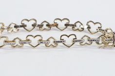 Introducing this exquisite bracelet featuring a charming hearts design that showcases both small and large hearts beautifully. The hearts measure 7 and 9 mm respectively, and they are elegantly joined together with a delicate bar embellished with milgrain detailing. Crafted with attention to detail, this bracelet comes in two stunning color options - yellow gold and white gold plated over a silver 925 stamp. The combination of colors adds a touch of sophistication and versatility to the piece, allowing it to complement a wide range of outfits and personal styles. With a length of 7 inches, this bracelet is designed to comfortably adorn your wrist and is secured with a safety clasp, ensuring it stays in place throughout the day. The vintage bracelet is in excellent condition, showcasing its White Gold Double Heart Bracelet For Valentine's Day, Fine Jewelry Heart Bracelet With Charm For Anniversary, Fine Jewelry Heart Charm Bracelet For Anniversary, Jubilee Heart Bracelet In Fine Jewelry Style, Valentine's Day White Gold Heart Cut Bracelet, Classic Heart Bracelet With Diamond Accents, White Gold Heart Diamond Bracelet For Valentine's Day, Fine Jewelry Heart-shaped Bracelets For Anniversary, Anniversary Bracelets With Heart Beads