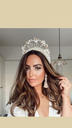 a woman with long hair wearing a tiara