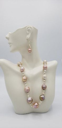 "Baroque pearls have a non-spherical shape that gives them a unique appearance. No two baroque pearl necklaces will ever be the same. The white to Pink and gold baroque pearl necklace choker is no exception, with a number of interestingly shaped pearls forming the 19-inch strand. The large baroque freshwater pearls have an AA quality luster and white body color. The baroque pearls are cultured in freshwater and have a thick nacre. The big baroque has a tone of white to pink and gold. This pearl Baroque Silver Pearl Drop Necklace, Baroque Pearl Beaded Necklace With Round Beads, Handmade Teardrop Pearl Necklace, Gold Baroque Pearl Beaded Necklaces, Gold Baroque Pearl Beaded Necklaces With Round Beads, Silver Baroque Pearl Necklace, Baroque Silver Pearl Necklace, Gold Beaded Necklaces With Baroque Pearls, Gold Beaded Necklaces With Baroque Pearl And Round Beads