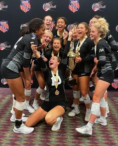 the women's soccer team is celebrating with their trophy and posing for a photo