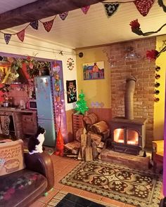 a living room filled with furniture and a fire place next to a brick wall covered in decorations