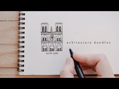 a hand is writing on an open notebook with a pen in front of it and the words architecture doodles