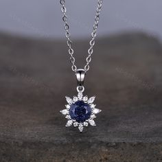 This beautiful Art Deco Galaxy Blue Sandstone Necklace features 1 carat round shaped center stone surrounded by Moissanite/Simulated Diamonds. For those who are looking for agate jewelry which is handcrafted in details, this unique agate necklace would be a perfect choice for you. Whether it be a Birthday gift for her, an anniversary gift her, or a celebration of yourself, this agate jewelry is the perfect gift from the heart. Alexandrite necklace: www.etsy.com/listing/1337968988/1ct-lab-alexand Brilliant Cut Sapphire Diamond Gemstones, Sapphire Diamond Necklace Fine Jewelry, Sapphire Round Diamond Necklace In Fine Jewelry Style, Sapphire Diamond Necklace In Round Shape, Sapphire Necklace With Brilliant Cut, Sapphire Diamond Round Necklace, Round Cut Sapphire Diamond Gemstones, Round Gemstones With Diamond Accents For Gifts, Round Cubic Zirconia Fine Jewelry Gemstones