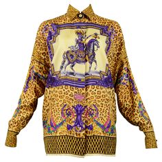 Resurrection is excited to offer a vintage Gianni Versace Couture silk oversized scarf blouse featuring a flap collar, decorative black and gold Medusa buttons, a front placket with hidden buttons, long sleeves, contrasting border print, and an all-over leopard print with a fancy baroque style horse and rider with gladiator skirt and pink Atelier Versace logos on the front and back. Versace Size 40 100% Silk Excellent Vintage Condition Authenticity Guaranteed Gladiator Skirt, Blue Bedrooms, Black Silk Shirt, Scarf Blouse, Versace Top, Baroque Print, Versace Gold, Versace Logo, Gold Baroque