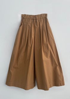 Wide leg ankle length trousers, featuring stitched down pleats in the front, and elasticized waistband, side pockets and back patch pockets. Cut in a crisp, luxurious medium weight poplin. Solid Cotton Bottoms With Pleated Waist, Cotton Wide Leg Pants With Pleated Waist, Solid Color Parachute Pants With Elastic Waistband For Workwear, Solid Parachute Pants With Elastic Waistband For Work, Workwear Parachute Pants With Elastic Waistband, Luxury Linen Bottoms With Patch Pockets, Workwear Parachute Pants With Elastic Waistband And Ankle-length, Luxury Pleated Cotton Bottoms, Cotton A-line Pleated Bottoms