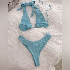 Color Truest To First Photo Bikini With Two Tops Options Beautiful Baby Blue Bright And Cute! Adjustable Ties High Waist Cheeky Bottoms Brand New Without Tags Out From Under Brand Top Size Large - Adjustable Can Fit Various Busts Second Top With Structured Bust Size Medium Also Adjustable Straps Bottoms Size Medium- Can Also Fit Small I Think Listing As Medium Size Bikini The Top Alone Was $50 The Second Top Is A Slightly Bolder Blue, You Could Even Pair With Just White Bikini Bottoms Too. Blue T-back Halter Top For Poolside, Blue Halter Top For Spring Beach Party, Fitted Blue Halter Top For Summer, Light Blue Halter Neck Top For Summer, Light Blue Triangle Top Swimwear For Sunbathing, Blue T-back Swimwear For Beach Party, Blue T-back Halter Top For Beachwear, Blue T-back Halter Top For Beach Party, Blue Halter Top For Poolside Spring Season