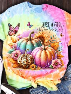 a tie dye shirt that says, just a girl who loves pumpkins and butterflies