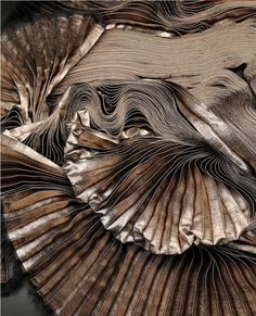 an intricately designed piece of art that is made out of wood and metallic foil