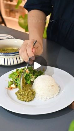 a person cutting food on top of a white plate