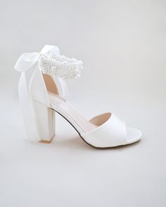 Satin block heel wedding sandals adorned with all over pearls ribbon strap . Elegance and feminine inspired wear for your special day. The delicate pearl beads are placed to create a graceful classic style. Simple and easy wear for bridal wear, bridesmaids, holiday party, wedding parties, and any special occasions. The light blue color can easily be your something blue.DETAILS:HEELS: 3.75 inchesCOLORS AVAILABLE: Ivory, White and Light BlueUPPER: Synthetic upper and liningMATERIALS: Manmade outso Shoes For Brides, Women Flats, Wedding Sandals, Wedding Parties, Bride Shoes, Light Blue Color, Something Blue, Ivory White, Easy Wear