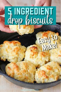 a pan filled with cheesy biscuits on top of a wooden table and text overlay reads 5 ingredient drop biscuits easy to make