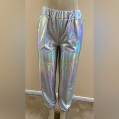 This Is A New Pair Of Iridescent Retro Looking Joggers With Pockets In A Size Small. Shiny Opalescent Silver Metallic Color, They Are Loose Fitting And Have Elastic Waist And Ankles Giving Off Those 1990s Club Vibes. Never Worn. Polyester/Cotton Blend. Measures: 12” Rise, 27” Inseam Clean, Pet And Smoke Free Home. Thank You! Metallic Stretch Casual Pants, Metallic Disco Bottoms For Spring, Shiny Fitted Casual Bottoms, Casual Metallic Bottoms With Elastic Waistband, Casual Metallic Stretch Pants, Iridescent Disco Bottoms For Party, Casual Shiny Metallic Bottoms, Iridescent Fitted Disco Bottoms, Casual Metallic Pants For Night Out