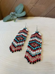 Hand beaded with glass seed beads. Earring lengths are 4.5 inches Earring widths are 1 inches Southwestern Beaded Dangle Earrings, Southwestern Style Beaded Dangle Earrings, Southwestern Style Beaded Earrings, Colorful Southwestern Beaded Earrings, Southwestern Colorful Beaded Dangle Earrings, Southwestern Style Colorful Beaded Dangle Earrings, Southwestern Tiny Beads Dangle Earrings, Bohemian Beaded Crystal Earrings With Round Beads, Bohemian Beaded Round Crystal Earrings