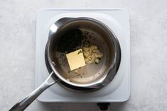 a pan with some food in it sitting on a stove top next to a spatula