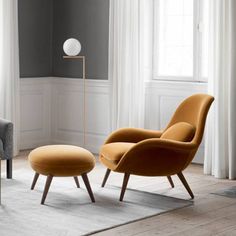 an orange chair and ottoman in a room