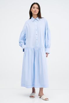 Meet our Ada Dress, the ultimate warm weather staple. She's a midi shirtdress handcrafted from 100% European poplin cotton, featuring pockets and a dropped gathered waistline that falls over your frame with ease. Her clean lines and sharp collar harmonize with dramatic dropped shoulders and full-bodied sleeves, elevating your style for any occasion.[SPLIT] Yada, in light blue, is 5'9" (175 cm) tall, wearing size XS. Shannon, in white, is 5'8" (173 cm) tall, wearing a size M. Maritza, in black an Easy Doodle, White Shirts Women, Tunic Hoodie, Modest Fashion Outfits, Sheer Fabric, Sheer Fabrics, Modest Fashion, Doodle Art, Clean Lines