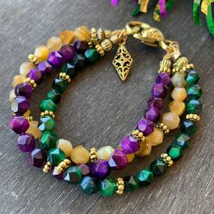 Celebrate Mardi Gras season whenever you feel like it with this three-strand bracelet. The colors of carnival are purple, green, and gold. Faceted Tiger's eye style stones in bold but not bright colors will take an outfit from great to fabulous. The green and purple are both rich and deep tones. The gold strand is a beautiful mustard toned yellow. Accented with just the right amount of gold metal beads makes this Mardi Gras bracelet gorgeous but not too extra.  Choose your length in the options Purple Jewelry For Mardi Gras, Spiritual Multi-strand Faceted Beads Bracelets, Spiritual Multi-strand Bracelets With Faceted Beads, Purple Beaded Jewelry For Mardi Gras, Handmade Gold Jewelry For Mardi Gras, Green Multi-strand Bracelets For Jewelry Making, Gold Multi-strand Spiritual Bracelet, Spiritual Gold Multi-strand Bracelets, Handmade Adjustable Jewelry For Mardi Gras