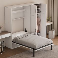 a bed with a white storage cabinet next to it and a desk in front of it