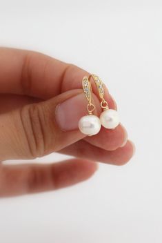 These beautiful gold pearl earrings are perfect for a bride or as a bridesmaids gift at her wedding. These delicate drop earrings are made with small freshwater pearls that are hanging from elegant gold over sterling silver ear hooks with tiny clear cubic zirconia. Very delicate! See last picture for matching Necklace also available in my Shop here: https://www.etsy.com/listing/167948530 These earrings will complement any outfit and will never get out of fashion. Total size of these gorgeous fre Gold Dangle Bridesmaid Earrings, Gold Dangle Earrings For Bridesmaids, Gold Dangle Bridal Earrings For Bridesmaid, Elegant Gold Earrings For Bridesmaids, Round Bridal Earrings With Ear Wire, Gold Pearl Charm Earrings For Wedding, Elegant Pearl White Bridal Earrings For Bridesmaid, Round Pearl Charm Bridal Earrings For Wedding, Bridal Round Pearl Charm Earrings For Wedding